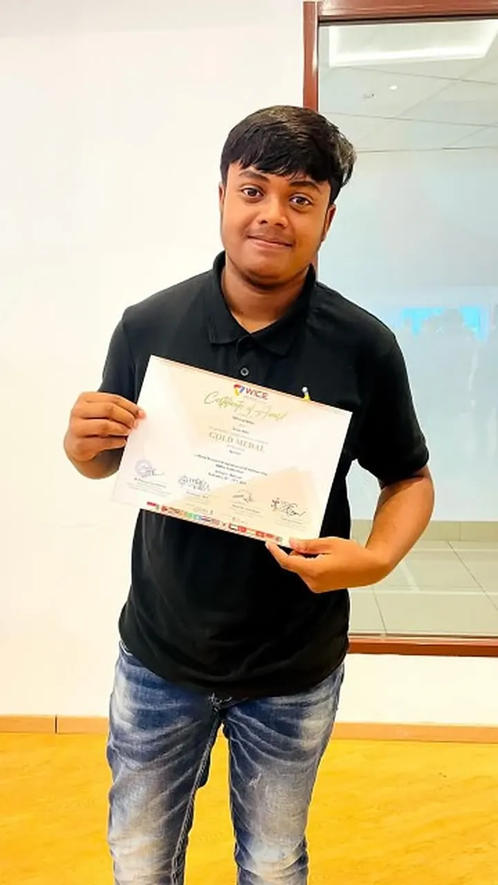Md Saad Islam holding his WICE Competition Gold Medal certificate